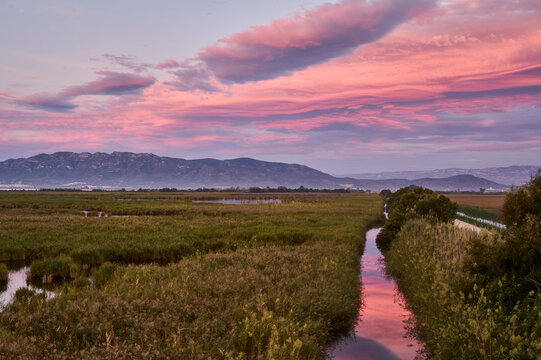 Spanish Wetlands at Sunset with Mountains and Vibrant Sky
