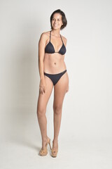 Fototapeta premium short hair, natural, no makeup, woman, white t-shirt, black pants, blue swimsuit, bikini, skates, casual, authentic, lifestyle, candid, minimal, female model, simplicity, everyday look, relaxed, comfo