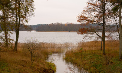 Beautiful lake in autumn, a stream flowing into it