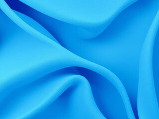 Obraz premium Flowing layers of blue textiles in wave pattern on gray background, artistic, wave