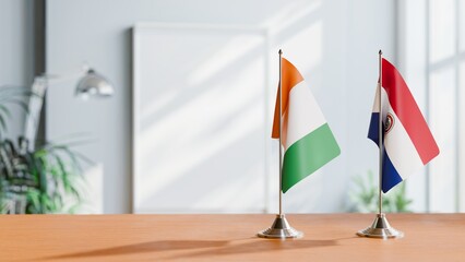 FLAGS OF IVORY COAST AND PARAGUAY ON TABLE