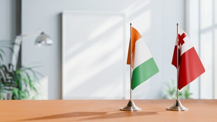 FLAGS OF IVORY COAST AND TONGA ON TABLE