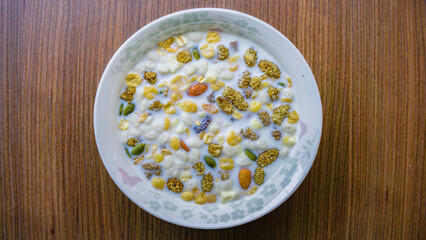 Bowl of milk with a mix of nuts and dried fruits