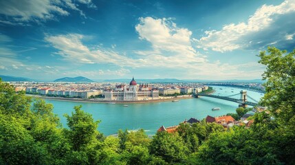 Naklejka premium A panoramic view of the Hungarian Parliament Building and the Chain Bridge in Budapest, with a clear blue sky and fluffy clouds, the river Danube flows in front of the parliament.