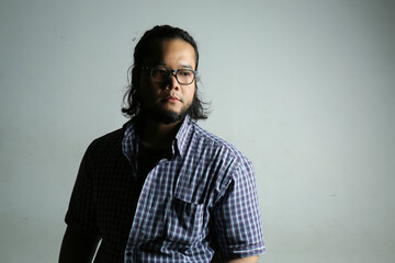 portrait of serious facial expressions of Asian men using low light photography techniques