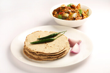 Jowar Roti or Jowar Bhakri with brinjal curry ,  a staple food in the Indian states of Maharashtra, Gujarat, and Karnataka. Sorghum is a versatile and nutrient-rich grain.