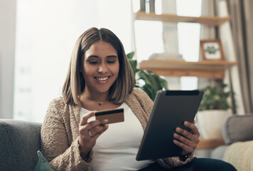 Home, woman and happy with credit card on tablet with ticket flights or accommodation payment for holiday. Female person, apartment and smile in living room on couch with online shopping or discounts