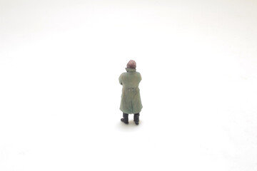 Lonely Figure In Winter Coat On Empty White Background