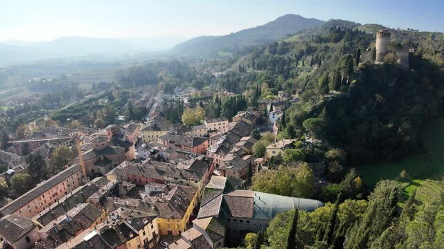 Aerial view of charming Brisighella village in Lamone valley, Italy, surrounded by Tuscan romagnolo apennines hills, showcasing timeless beauty and Brisighella Castle or Rocca Manfrediana in Italy