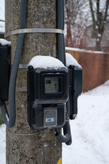 Electric meters for household consumers in private homes hang on a pole