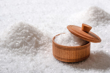 Wooden bowl of white salt close up. Salt texture