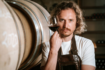 Winemaker Inspecting Red Wine in Cellar