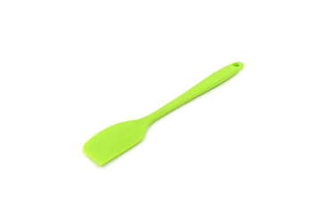 A Geen baking spatula on a white background