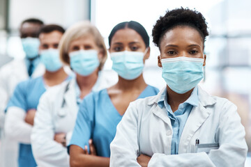 Confidence, doctors and nurses in portrait with mask, diversity and support in hospital healthcare. Ppe, safety and medical team with pride, trust and group of people with arms crossed in clinic