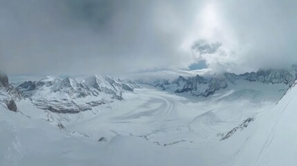 A panoramic view of a snowy mountain range with a glacier in the foreground. The sky is overcast and the sun is shining through the clouds.