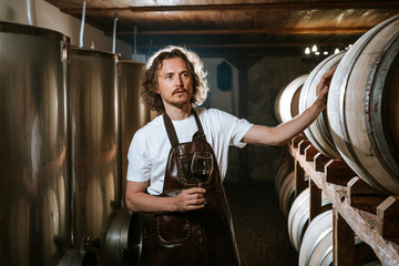 Winemaker Inspecting Red Wine in Cellar