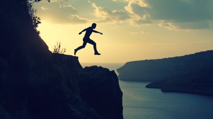 Silhouette of a Man Jumping Between Two Cliffs at Sunset
