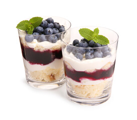 Tasty trifle dessert. Sponge cake, blueberries, jam and whipped cream in glasses isolated on white