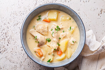 Chicken stew in creamy sauce with potatoes and carrots. Comfort food concept.