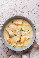 Chicken stew in creamy sauce with potatoes and carrots. Comfort food concept.