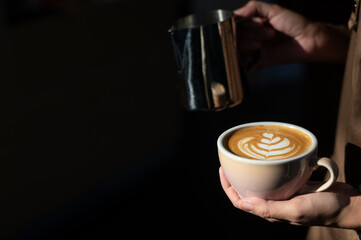 a cup of latte with a heart on it