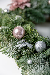 Beautiful Christmas wreath decorated with pine cones, berries, and stars on a white background. Christmas garland. Copy space. New year party