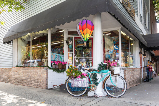 BREVARD, NORTH CAROLINA, USA-9 OCTOBER 2022: O. P. Taylor's toy store, showing exterior corner entrance with flower-covered bicycle on display.