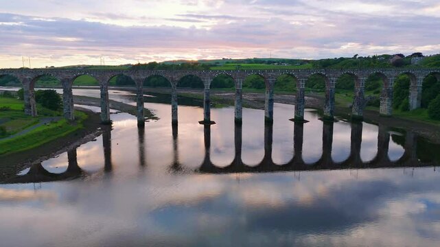 Berwick, Northumberland, UK, June 19, 2024; sunset aerial rise up/drop down clip of the Royal Border Bridge Viaduct, Berwick, Berwick-upon-Tweed, Northumberland, England, UK.