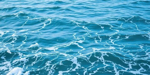 Obraz premium Blue turquoise ocean water with white foamy waves creating a tranquil texture, serene, peaceful, ocean