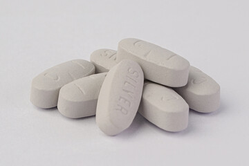 White pills on white background. set of white oval pills or medical drugs.