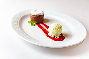 Gourmet Chocolate Cupcake and Ice Cream dessert on white plate isolated on white background