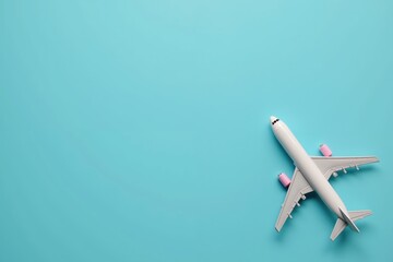 Minimalist airplane on blue background: travel and aviation concept in pastel colors.