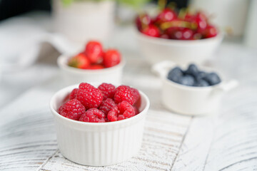 morning breakfast, juicy berries in a light plate, cherries, strawberries, raspberries