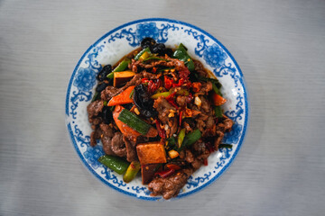 Spicy Chinese dish made with stir fried beef, carrot and other vegetables and a lot of chili which is common from the south of China