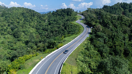 Road number three, Nan Province, aerial view of a beautiful road through the mountains full of green trees. Travel concept, transportation concept.