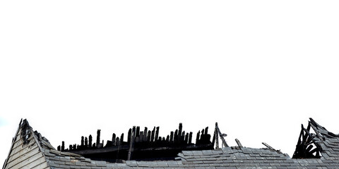 Fototapeta premium Fire damaged roof with blackened wooden beams isolated against a white for use as a background 