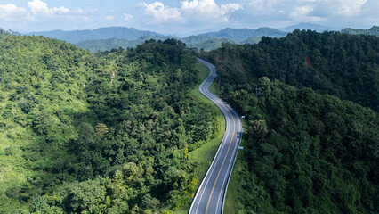 Road number three, Nan Province, aerial view of a beautiful road through the mountains full of green trees. Travel concept, transportation concept.