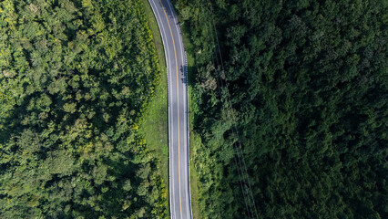 Road number three, Nan Province, aerial view of a beautiful road through the mountains full of green trees. Travel concept, transportation concept.