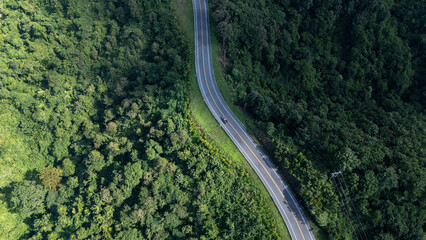 Road number three, Nan Province, aerial view of a beautiful road through the mountains full of green trees. Travel concept, transportation concept.