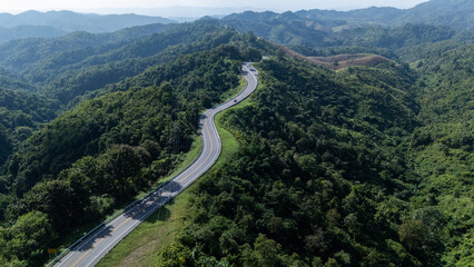 Road number three, Nan Province, aerial view of a beautiful road through the mountains full of green trees. Travel concept, transportation concept.