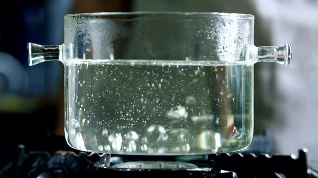 Boiling water on stove . Water boiling in glass pot	