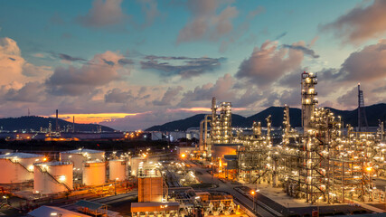 Fototapeta premium Oil and gas refinery industrial storage tank with oil and gas refinery plant at night, Refinery oil and gas power energy industrial, Oil and gas refinery petrochemical product plant pipeline steel.