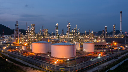 Oil and gas refinery industrial storage tank with oil and gas refinery plant at night, Refinery oil...
