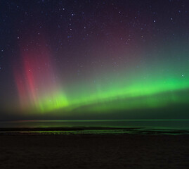 Aurora borealis over the Baltic Sea at night in Latvia