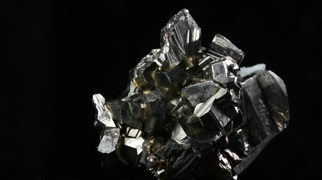 Iron Pyrite crystals (Iron sulfide - "Fools Gold") and quartz crystals rotating slowly against a black background [Bulgaria]