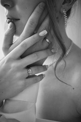 Young blonde girl is getting married. White dress and veil. Black and white photo.