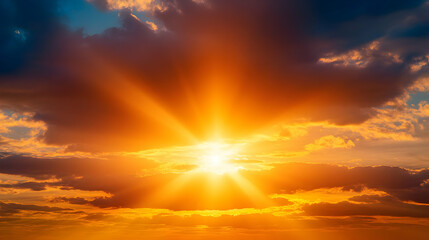 Fototapeta premium Golden Sunset Sky with Bright Sun Rays Shining Through Clouds