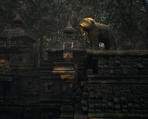 Decorative elephant on wall of an ancient temple in woodland. 3D render.