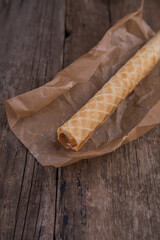 Wafer roll with boiled condensed milk on a wooden table