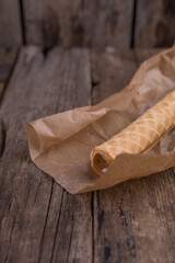 Wafer roll with boiled condensed milk on a wooden table